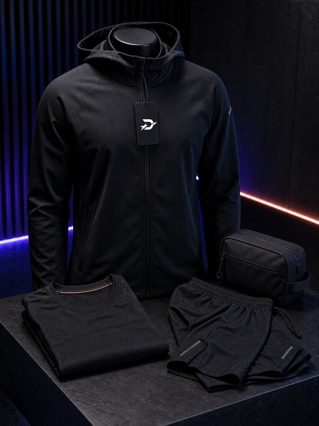 Black Draxstar apparel capsule product photo with hoodie, folded training tee, shorts, and gear pouch.